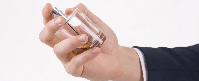 Male hand holding cologne