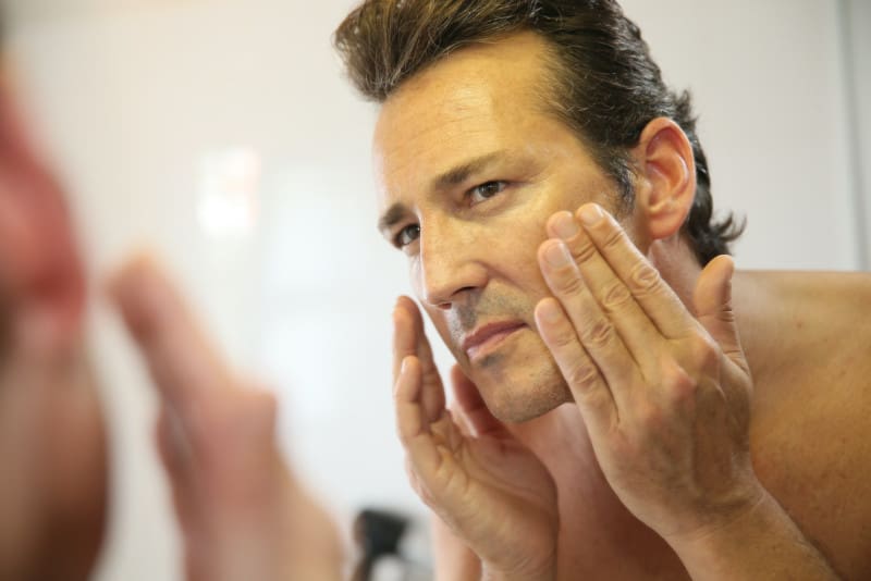 Man Applying Lotion 
