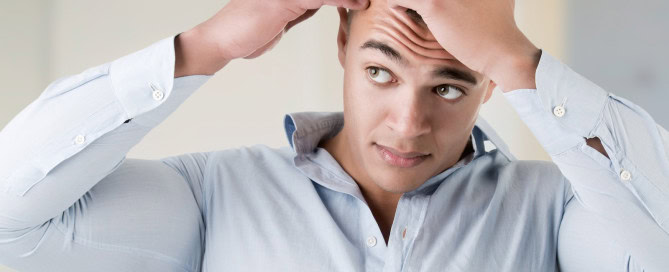Man checking his thinning hairline
