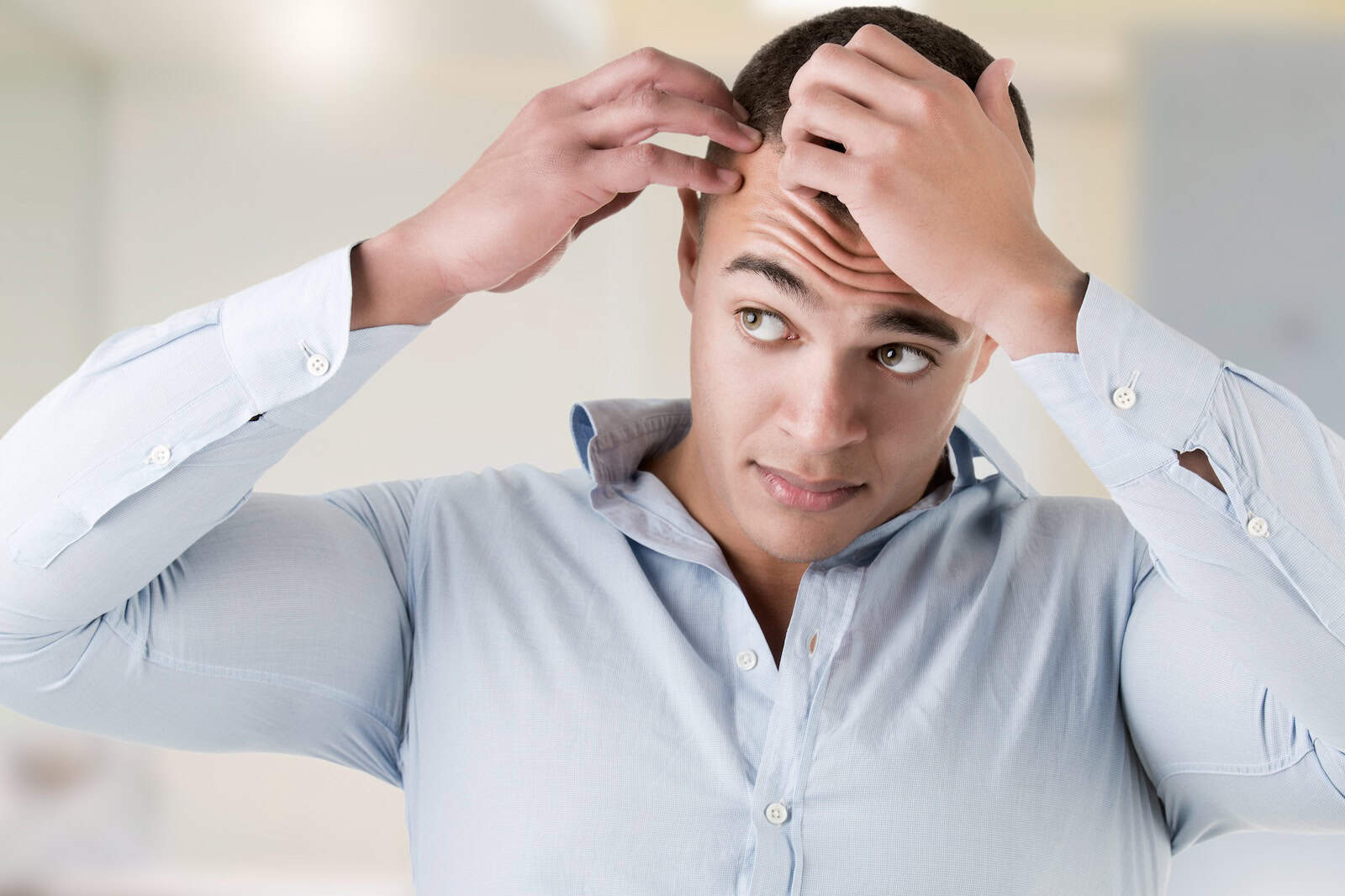 Man checking his thinning hairline