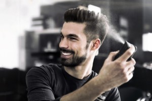 Cool fashion guy spraying hair